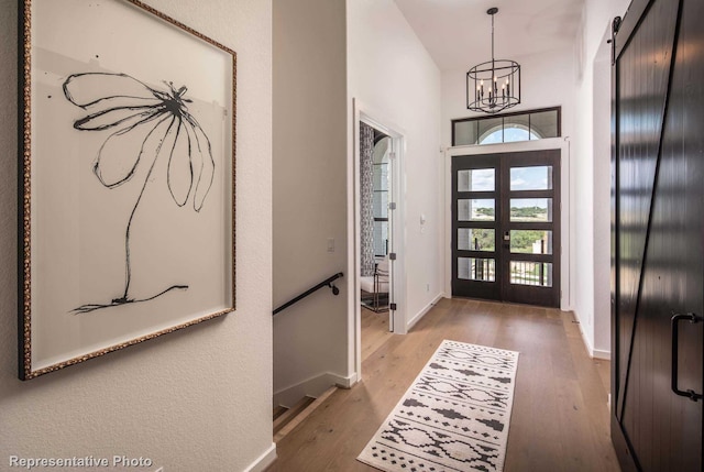 4121 Buffalo Clover Dr, Aubrey, TX 76227 - foyer entrance with a chandelier, french doors, wood finished floors, and a high ceiling