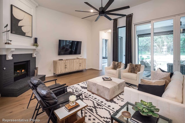 4121 Buffalo Clover Dr, Aubrey, TX 76227 - living room featuring a ceiling fan, wood finished floors, and a fireplace