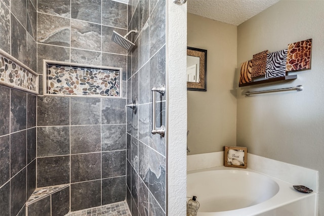 bathroom featuring separate shower and tub and a textured ceiling