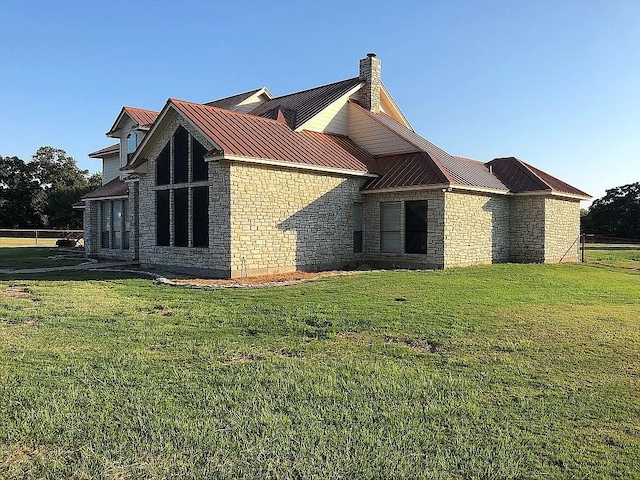 view of side of home with a lawn