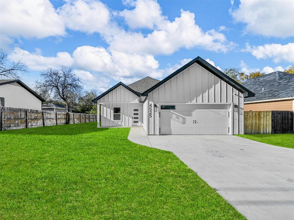 modern inspired farmhouse featuring a front yard and a garage