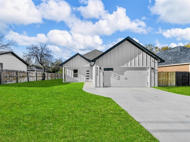 modern inspired farmhouse featuring a front yard and a garage