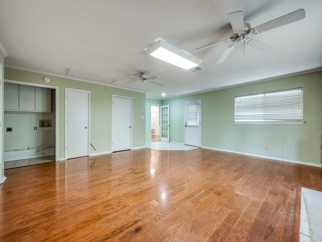 empty room featuring ornamental molding, ceiling fan, and light hardwood / wood-style floors