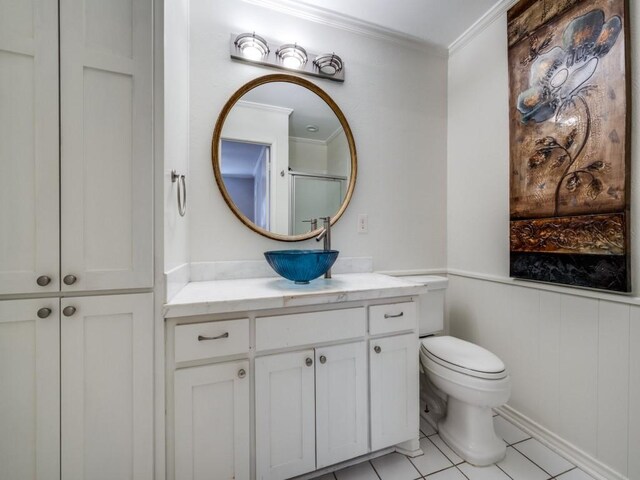 bathroom with ornamental molding, vanity, tile patterned floors, and toilet