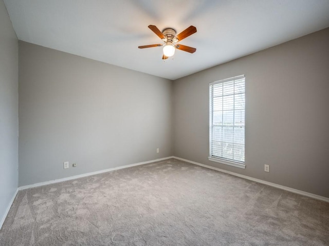 unfurnished room with light colored carpet and ceiling fan