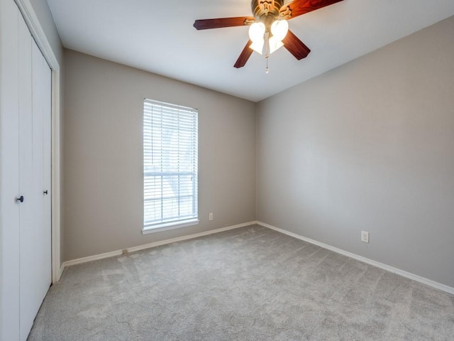 empty room featuring light carpet and ceiling fan