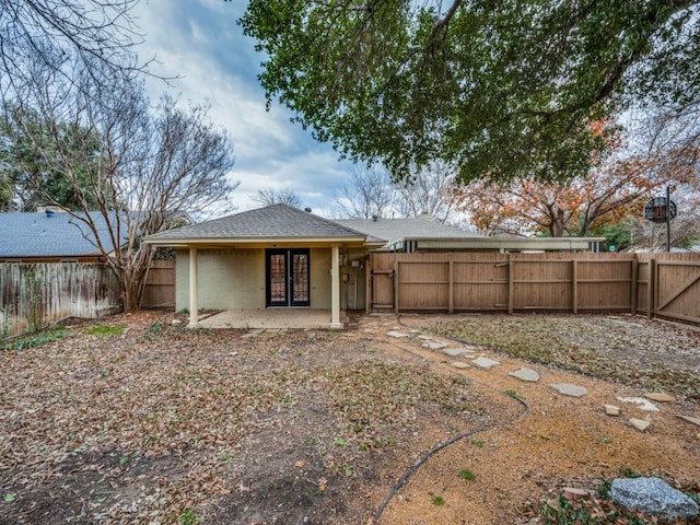 back of property with a patio