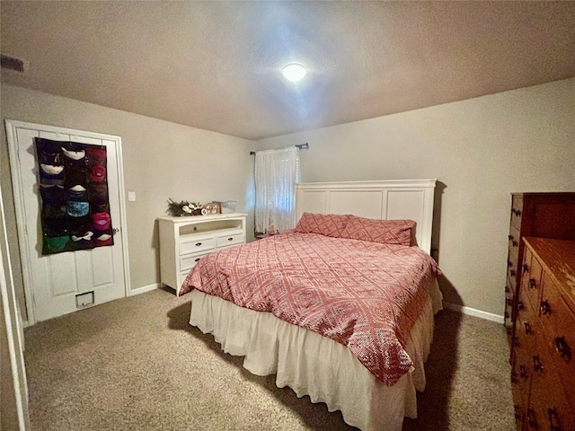 bedroom with dark colored carpet