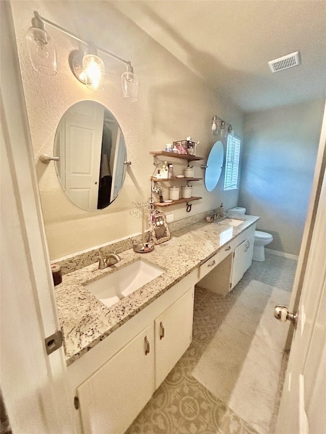 bathroom with tile patterned floors, vanity, and toilet