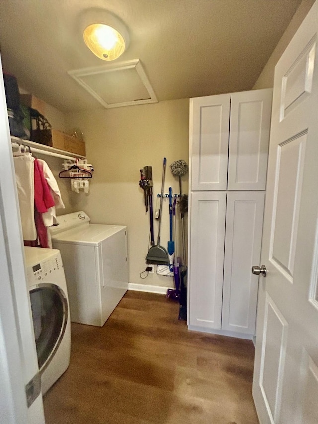 laundry area with washer and dryer, cabinets, and dark wood-type flooring