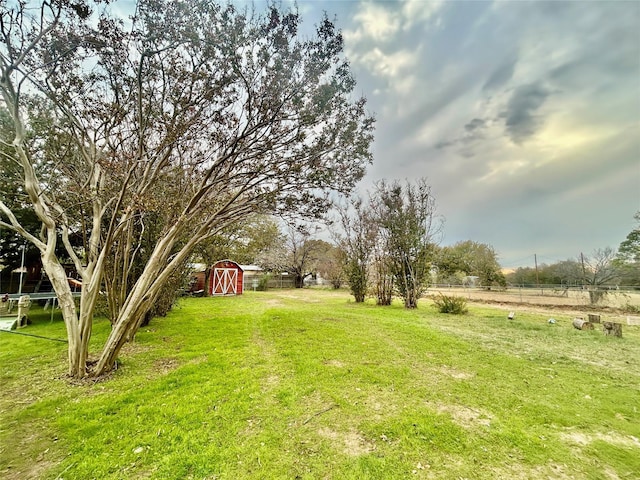 view of yard featuring a storage unit and a rural view