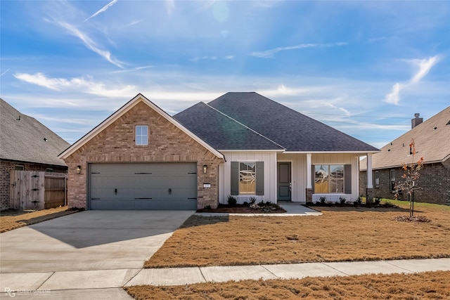 view of front of home with a garage and a front lawn