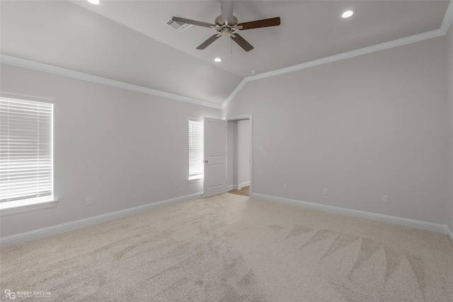 carpeted empty room with ceiling fan, vaulted ceiling, and ornamental molding