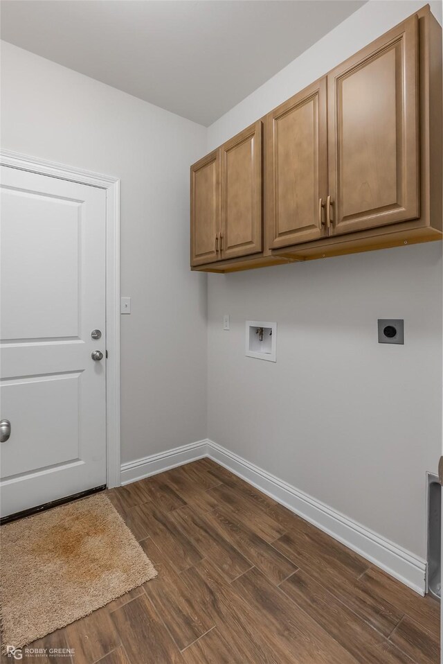 laundry area featuring electric dryer hookup, cabinets, dark hardwood / wood-style flooring, and washer hookup