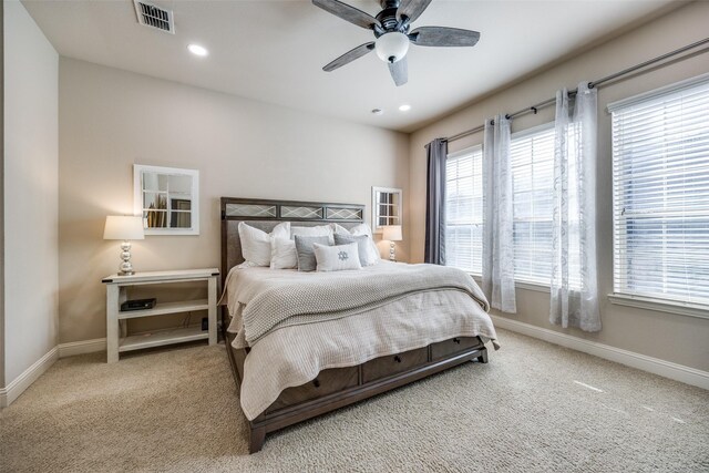 bedroom with ceiling fan and light colored carpet