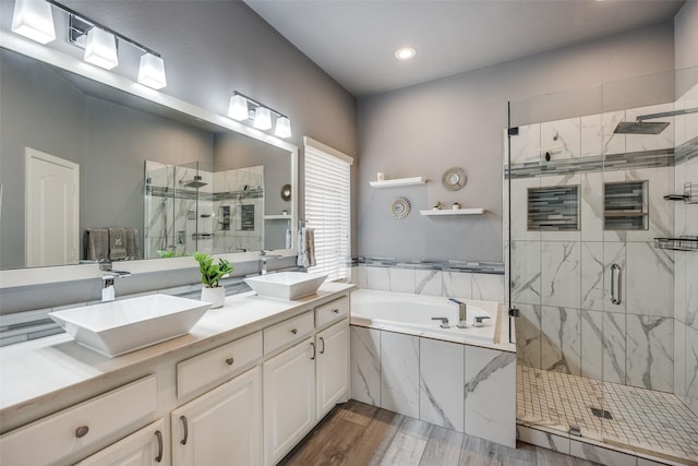 bathroom with vanity, hardwood / wood-style flooring, and separate shower and tub