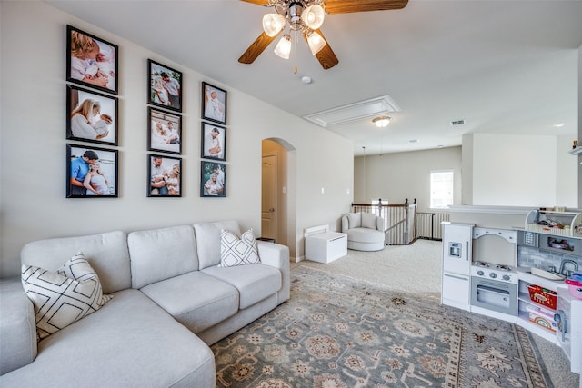 living room featuring carpet flooring and ceiling fan