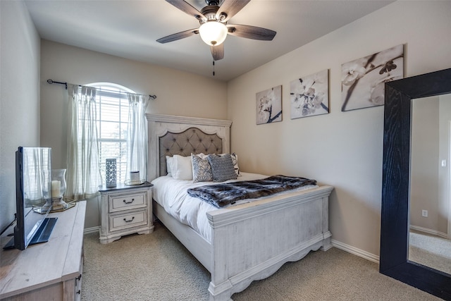 bedroom featuring ceiling fan and light carpet