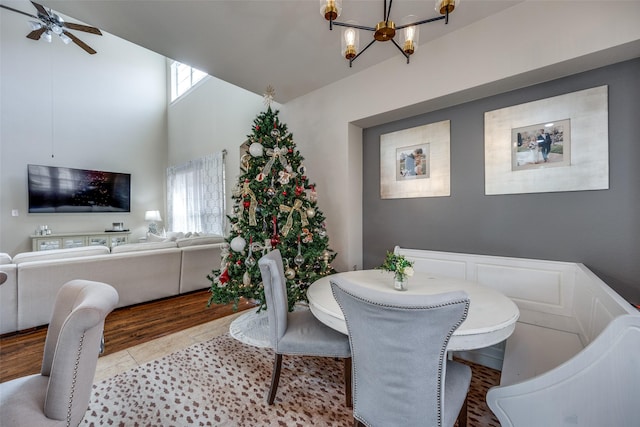 dining area with light tile patterned floors, ceiling fan with notable chandelier, and plenty of natural light