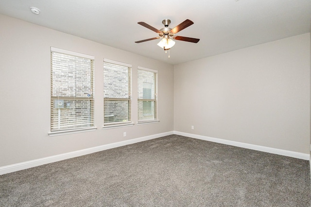 carpeted spare room featuring ceiling fan