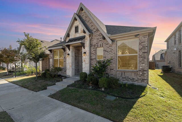 2013 Barx Dr, Little Elm, TX 75068 - view of front facade featuring a yard, a shingled roof, brick siding, and stone siding