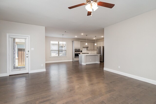 2013 Barx Dr, Little Elm, TX 75068 - unfurnished living room with ceiling fan, recessed lighting, dark wood-type flooring, and a chandelier