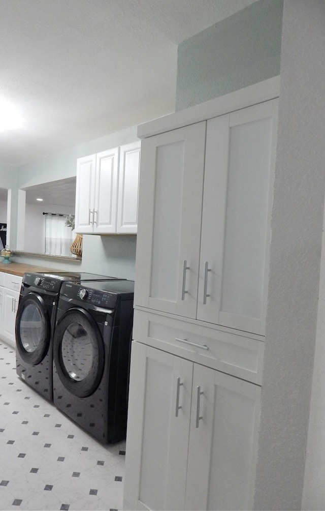 laundry room featuring cabinets and separate washer and dryer