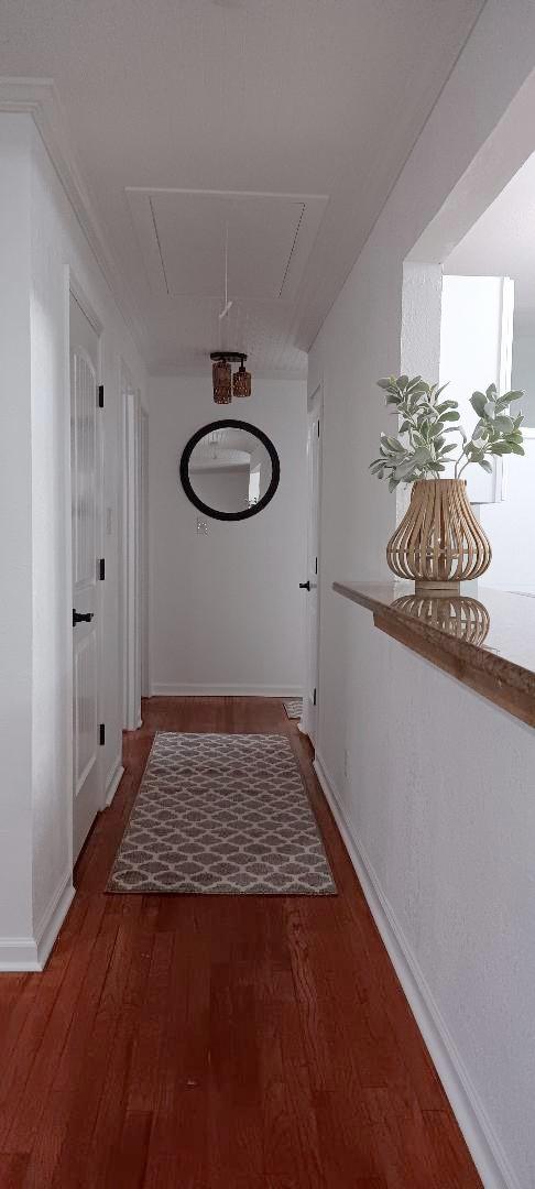 corridor featuring dark hardwood / wood-style flooring