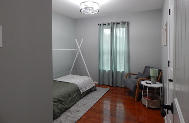 bedroom with dark hardwood / wood-style flooring