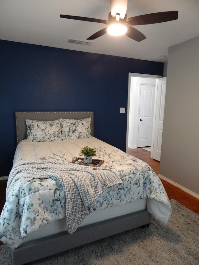 bedroom featuring hardwood / wood-style floors and ceiling fan