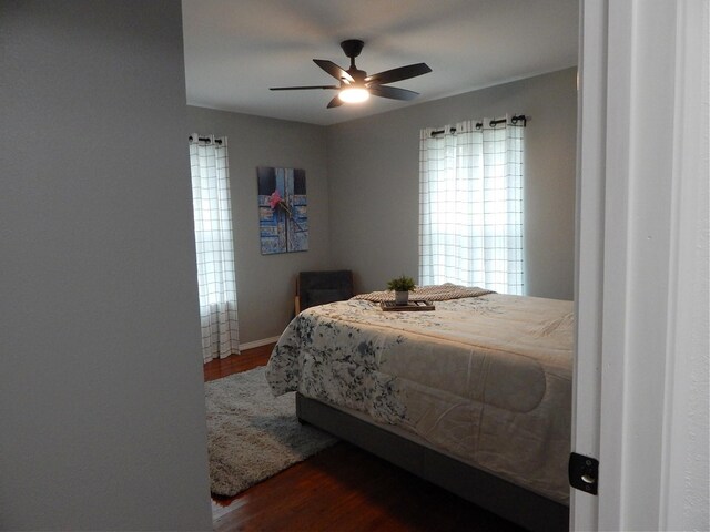 bedroom with ceiling fan and dark wood-type flooring