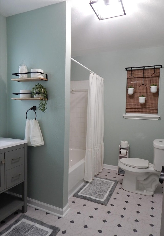 full bathroom featuring vanity, shower / tub combo, and toilet