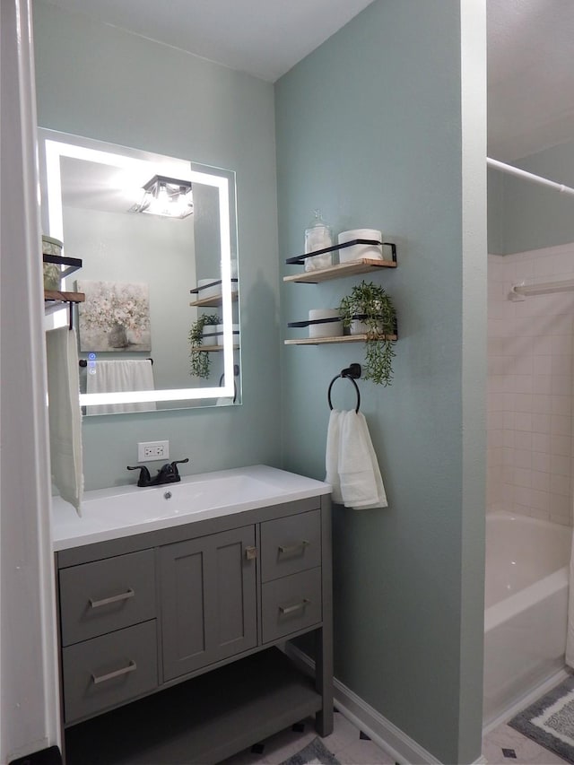 bathroom featuring vanity and tiled shower / bath