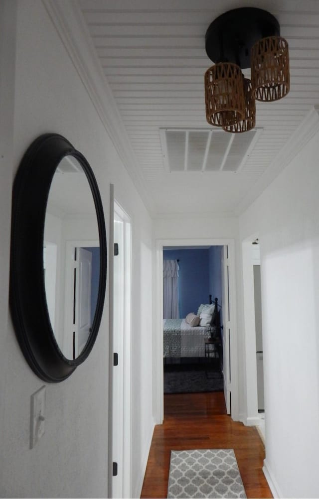 hall with dark hardwood / wood-style flooring and crown molding