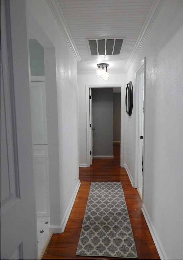 hallway with dark hardwood / wood-style flooring and ornamental molding