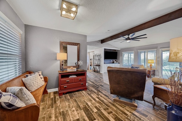 living room with a textured ceiling, vaulted ceiling with beams, dark hardwood / wood-style floors, and ceiling fan