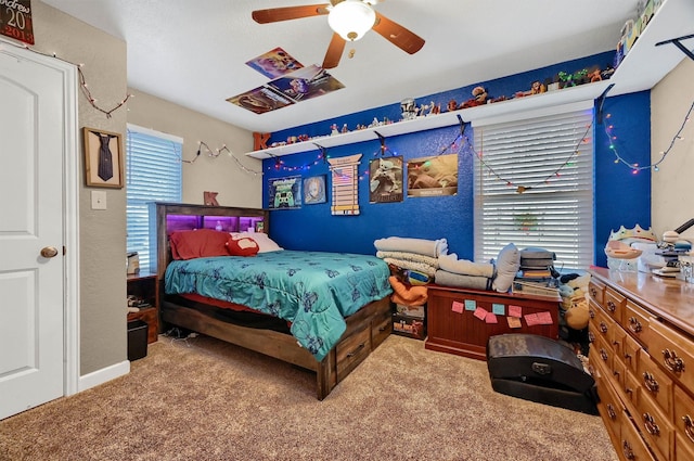 carpeted bedroom with ceiling fan and multiple windows