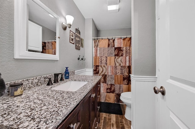 bathroom featuring hardwood / wood-style floors, vanity, and toilet