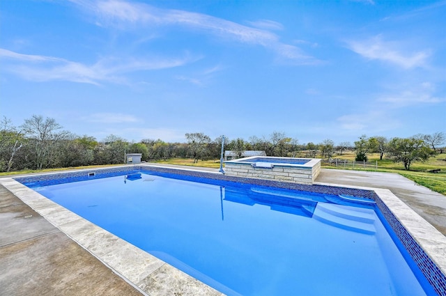 view of swimming pool featuring an in ground hot tub