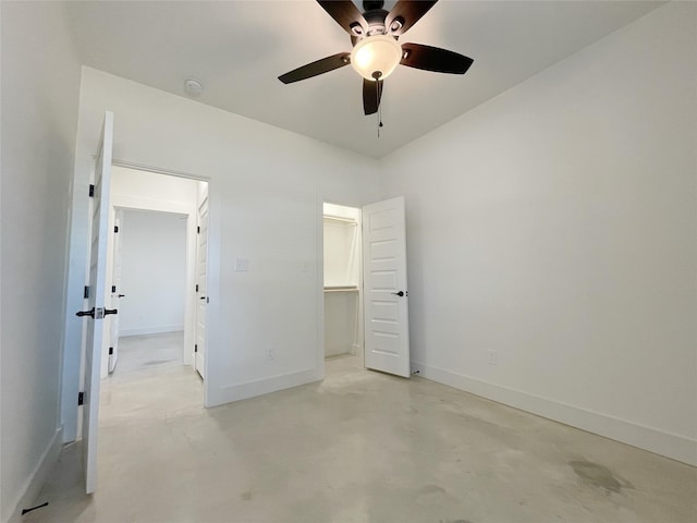 unfurnished bedroom featuring a spacious closet and ceiling fan