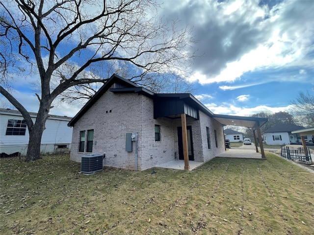 view of property exterior featuring a patio, central AC unit, and a lawn