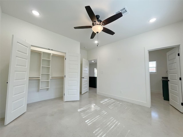 unfurnished bedroom with ceiling fan and a closet