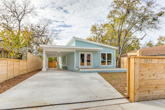 view of front of house featuring a carport and french doors