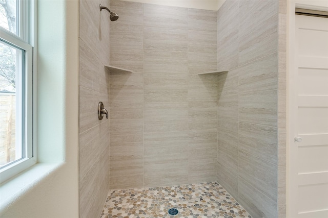 bathroom with a tile shower