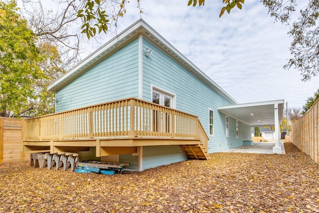 rear view of house with a patio area and a wooden deck