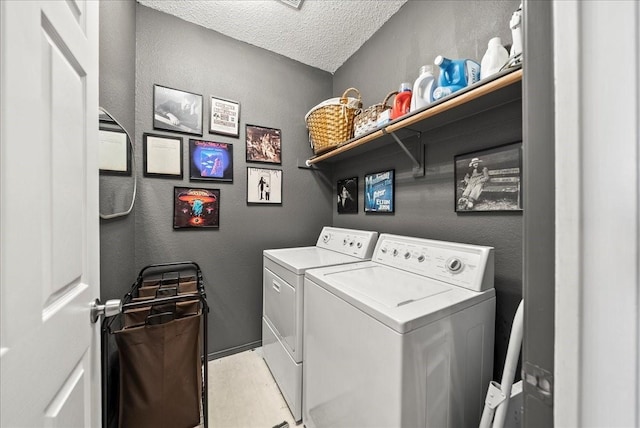 laundry room with washing machine and dryer and a textured ceiling