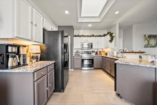 kitchen featuring sink, white cabinetry, gray cabinets, kitchen peninsula, and stainless steel appliances