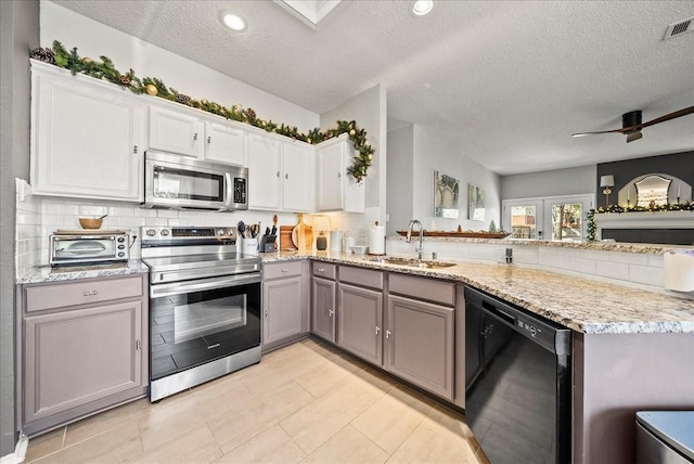 kitchen featuring white cabinetry, stainless steel appliances, and kitchen peninsula