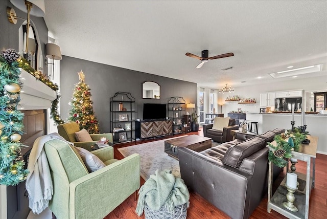 living room with ceiling fan and dark hardwood / wood-style flooring