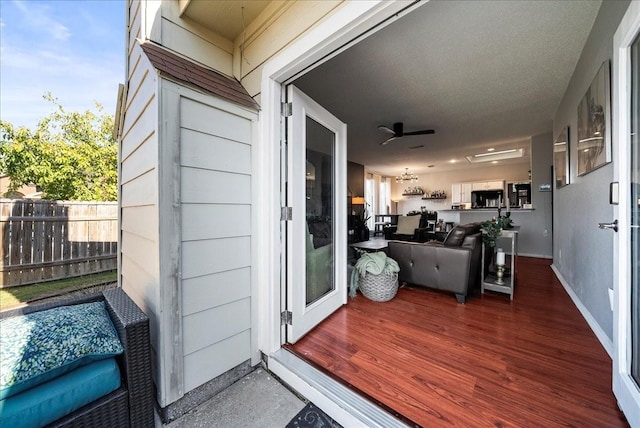 doorway to property featuring ceiling fan